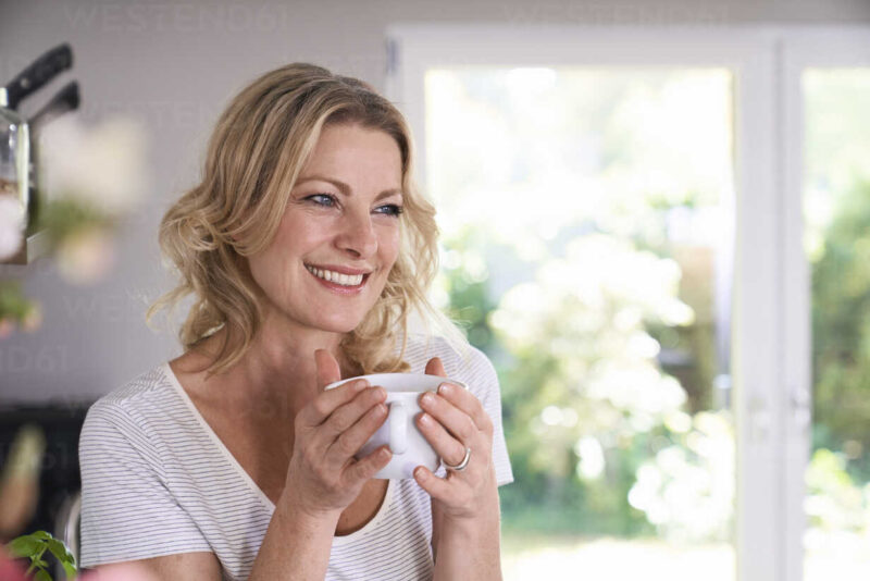 smiling woman drinking coffee